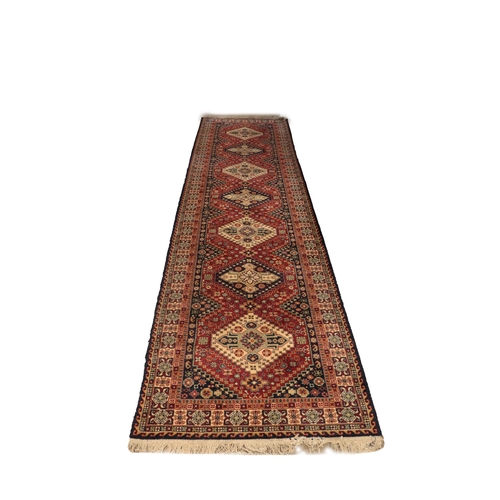 1184 - A 20th Century Middle Eastern style woolen Carpet Runner, by 'Jeravin' Belgium, with label, the burg... 