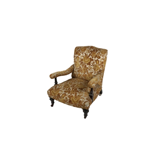 550 - A Victorian mahogany framed Low Armchair, covered in floral brocade in the manner of Howard, on fron... 