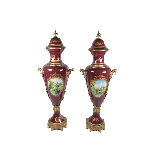 555 - A pair of monumental Regency style ormolu mounted and gilded metal Urns, with decorative painted pan... 