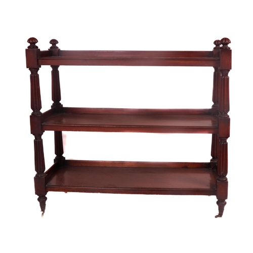 560 - An Irish William IV mahogany three tier Dumbwaiter, with reeded pillar supports and curved finials o... 