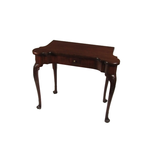 577 - A fine quality Irish Georgian period mahogany fold-over Card Table, the shaped top opening to reveal... 