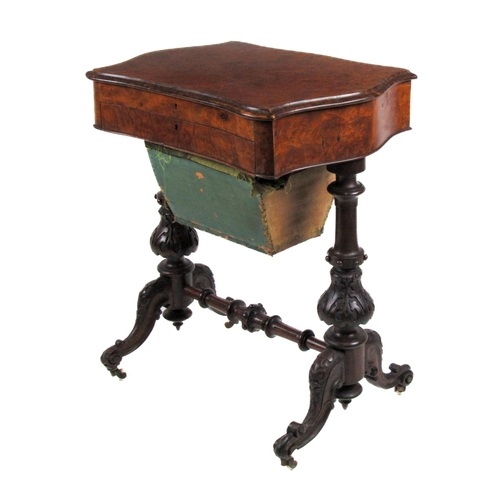 616 - A Victorian serpentine shaped Ladies walnut Work / Writing Table, the hinged top opening to reveal a... 