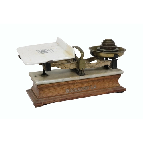 656 - An Edwardian W. & T. Avery Weighing Scales, with weights, porcelain balance on an oak base. (1)... 