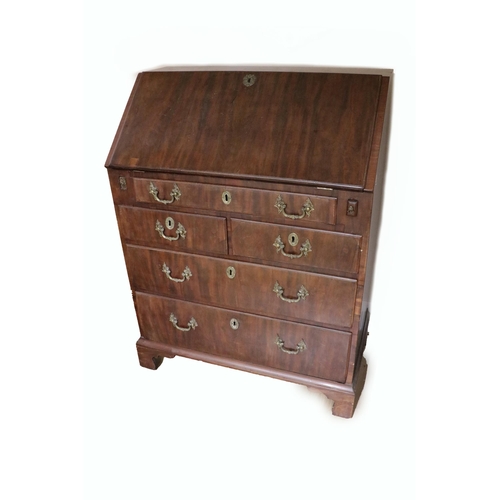 725 - A Georgian period mahogany slope front Bureau, of small proportions, opening to reveal a fitted inte... 