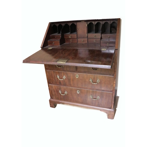 725 - A Georgian period mahogany slope front Bureau, of small proportions, opening to reveal a fitted inte... 