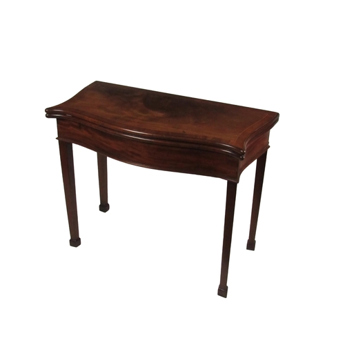 774 - A Georgian mahogany serpentine shaped fold-over Card Table, the top with string inlay, opening to re... 