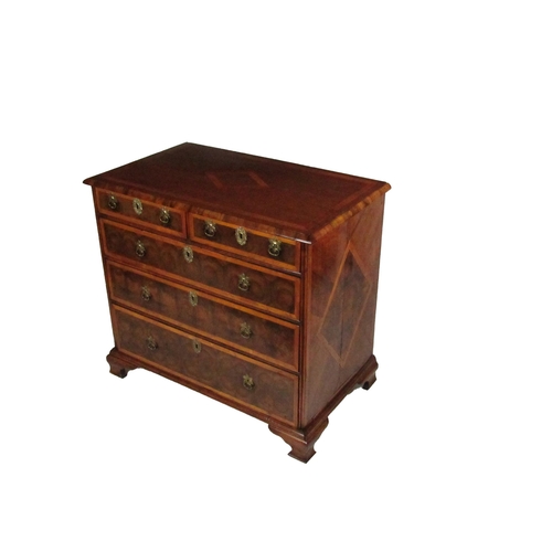 797 - An attractive 18th Century English walnut oyster veneer Chest of Drawers, the moulded top with cross... 