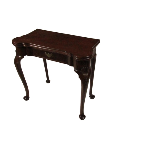 798 - An Irish Georgian period mahogany fold-over Card Table, the shaped top opening to reveal a baize cov... 