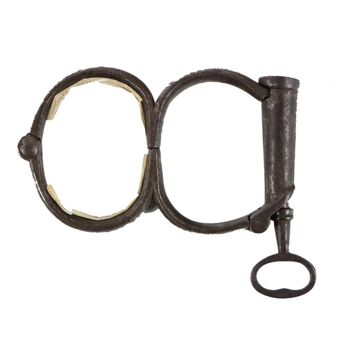 636 - [Michael Collins] A set of heavy steel Handcuffs, with key, said to have been used by Michael Collin... 