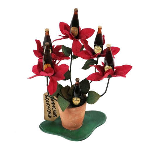 820 - Guinness Advertisement: Guinnesses Goodforia, a rare model of a flower pot with red flowers iss... 