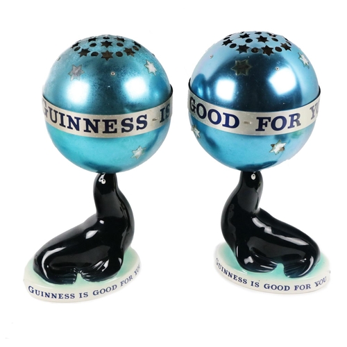 821 - Advertisement: [Guinness & Co.] Two rare Carltonware porcelain Lamps, modelled as Sea lions with... 