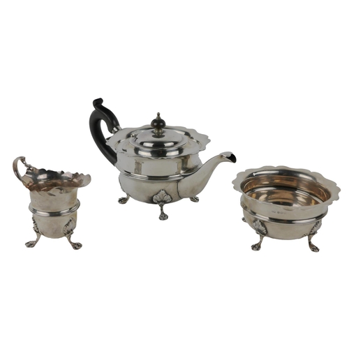 59 - A three-piece silver Tea Set, comprising teapot, sugar bowl and cream jug, with shaped rims, gi... 