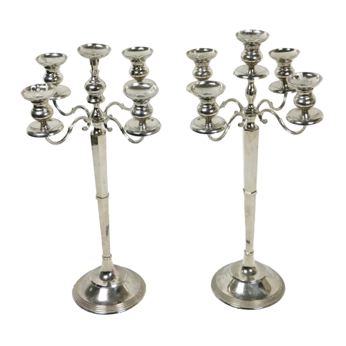 7 - A pair of large stainless steel four branch - five light Candlesticks, on circular step bases, appro... 