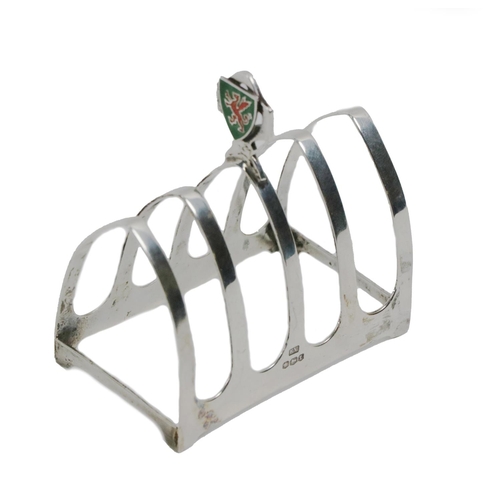 71 - A silver five bar Toast Rack, by Sheffield c. 1936, with plain arch shaped bars, and a centre finger... 