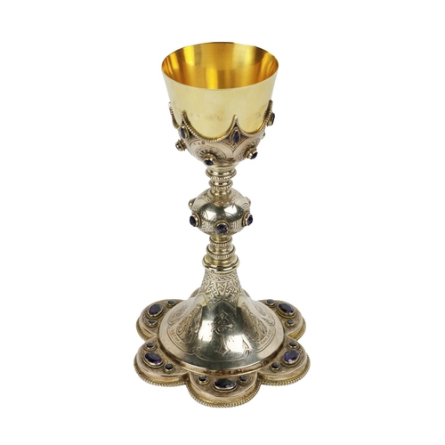 A 19th Century Irish silver and gold Chalice, the removable 18ct gold Cup (approx. 7.5 ounces) hallmarked 'G. & R.' (Gunning & Reynolds) Dublin, set in an ornate silver base in the manner of Augustus Pugin, c. 1908, with amethyst and ruby stone inset, decorated with etched saints, 'Saint Patrick, Saint Brigid & others,' the underneath inscribed 'presented to Mothers Mary Bernard Hackett on the occasion of her Jubilee, 24, November 1903' hallmarked  G. & R, (Gunning & Reynolds) approx. 26cms high, 30.6 ounces. (1)