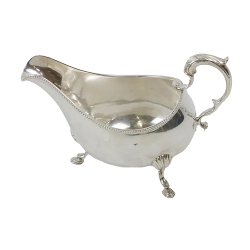 108 - An attractive heavy English silver Sauceboat, with gadroon edge, ornate scroll handle on hoof feet, ... 