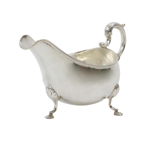 108 - An attractive heavy English silver Sauceboat, with gadroon edge, ornate scroll handle on hoof feet, ... 