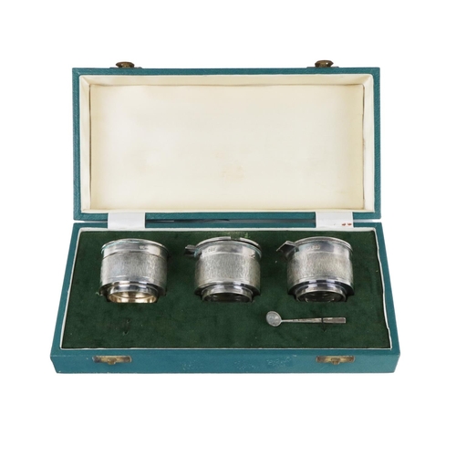 112 - A cased three part Irish silver Condiment Set, of modern design by Brian Clarke?, comprising salt, p... 