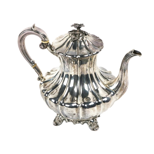 128 - A large Victorian silver Teapot, by John Welby, London, 1838, the hinged lid with floral capital, sc... 