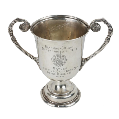 134 - Silver: Sporting [Blackrock College] a two handled silver Trophy Cup, with ornate scroll silver hand... 