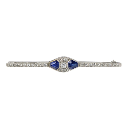 188 - An Art Deco Chanel style design Ladies white gold bar Brooch, the centre set with two sapphire taper... 