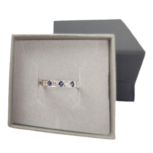 207 - A fine quality sapphire and diamond Ladies Eternity Ring, set with four .06ct diamonds, and three .0... 