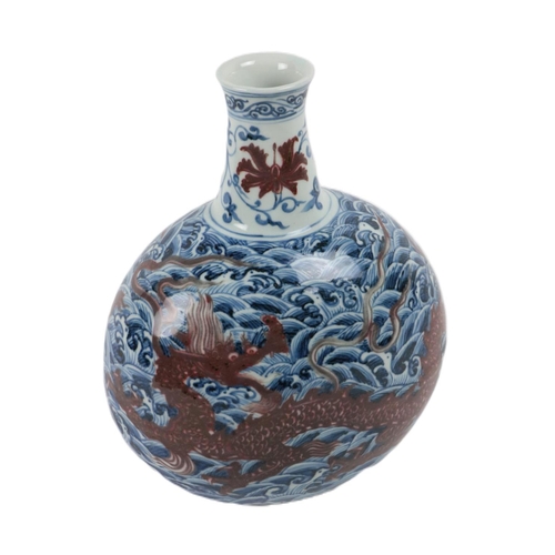 223 - An attractive Chinese blue and white bottle shaped Vase, with ware decoration and floating iron red ... 