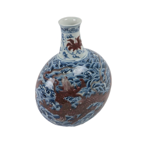 223 - An attractive Chinese blue and white bottle shaped Vase, with ware decoration and floating iron red ... 