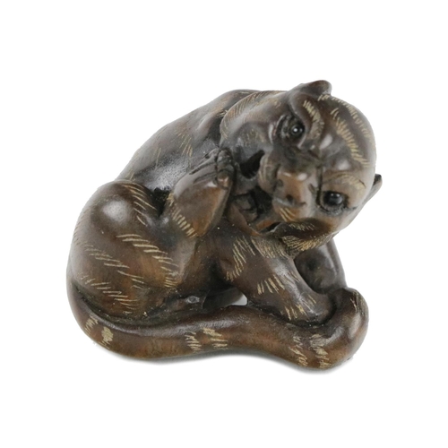 241 - A fine quality early 20th Century Japanese carved Netsuke, of a recumbent tiger, with head turned wi... 