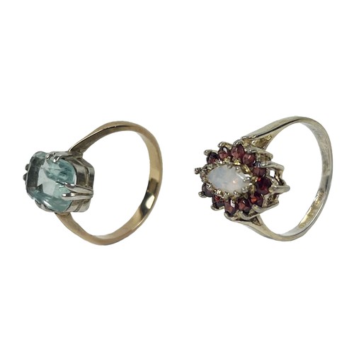 203 - A Ladies silver gilt Ring Set, with central oval opal stone, surrounded by a ruby coloured garnet cl... 