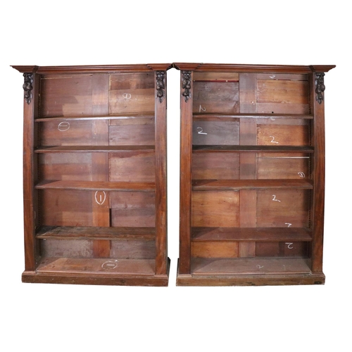 504 - A pair of Victorian mahogany Open Bookcases, the inverted moulded cornice with carved fruit garland ... 