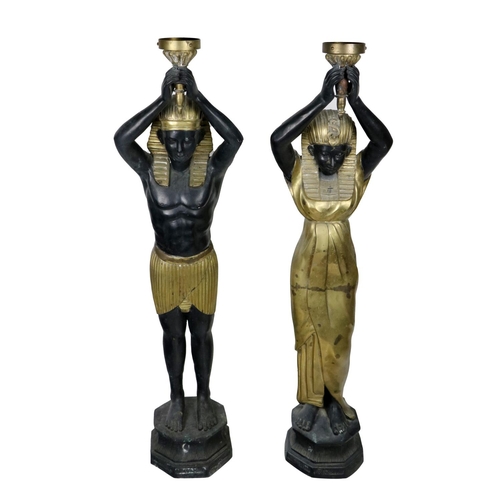 478 - A pair of large bronze and gilt bronze Floor Lights, in the form of Ancient Egyptian women, each hol... 