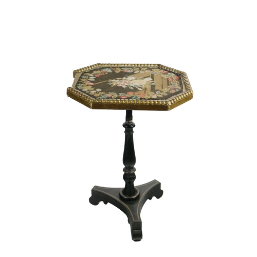 538 - A 19th Century ebonised Centre Table, the octagonal top with floral needlework inset with beaded gil... 