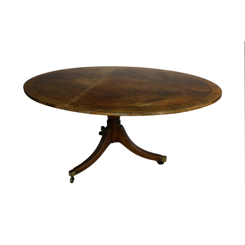 541 - A Regency mahogany oval flip top Centre Table, the top with wide satinwood crossbanding with ebony s... 