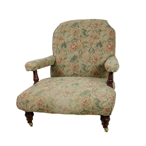 547 - A Victorian oak framed Low Armchair, in the manner of Howard, covered in floral fabric on front... 