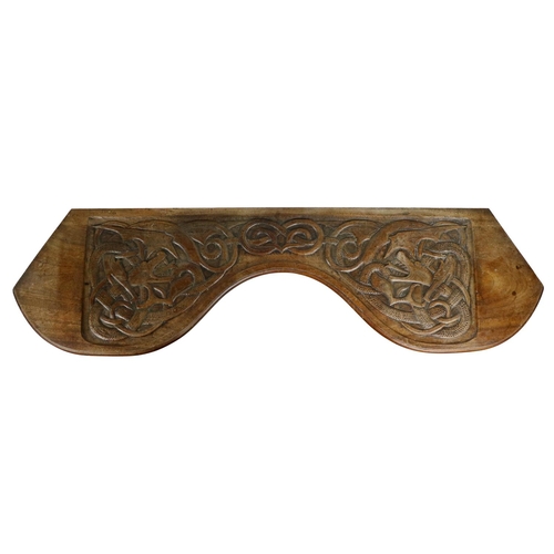 550 - A late 19th Century / early 20th Century Celtic Revival carved Window Stool, (Limerick), the shaped ... 