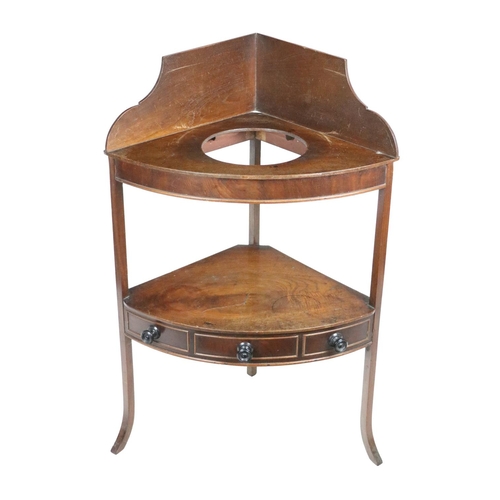 557 - A Georgian mahogany Corner Washstand, with gallery back above open section on a platform base on sin... 