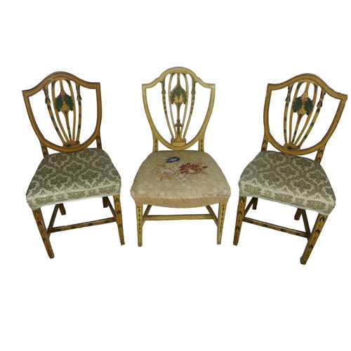 571 - Three 19th Century painted Hepplewhite shield back Side Chairs, with upholstered seats on square tap... 