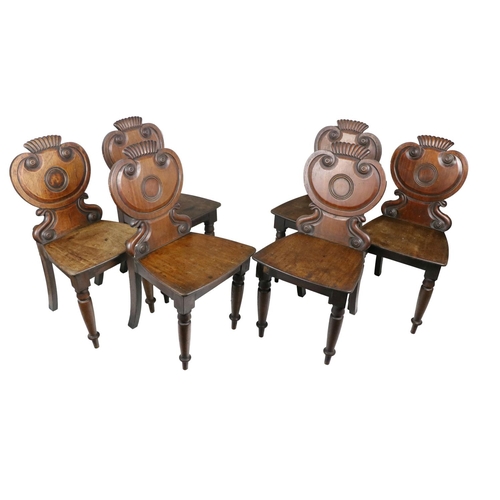 631 - A set of 6 William IV Irish mahogany Hall Chairs, in the manner of Graham, Clonmel, each with shield... 