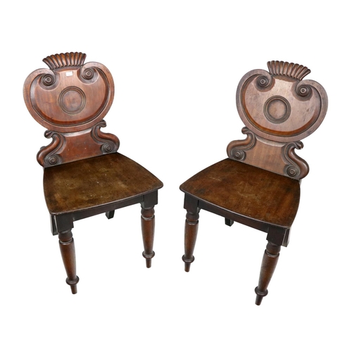 631 - A set of 6 William IV Irish mahogany Hall Chairs, in the manner of Graham, Clonmel, each with shield... 