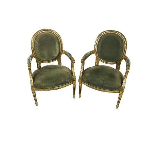 667 - A pair of attractive 19th Century French giltwood Fauteuils, each with oval back and scroll open arm... 