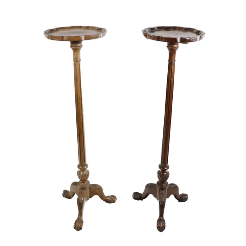 686 - A pair of attractive mahogany Torchers, with shaped pie crust tops on reeded pillars with heavy carv... 