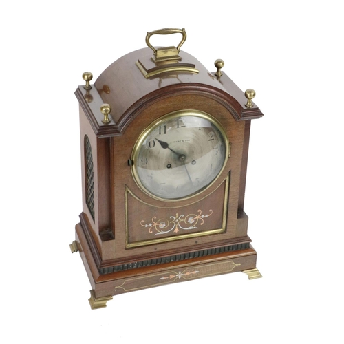 718 - An attractive Irish mahogany cased Mantel Clock, Edwardian, with domed top with brass finials and ca... 