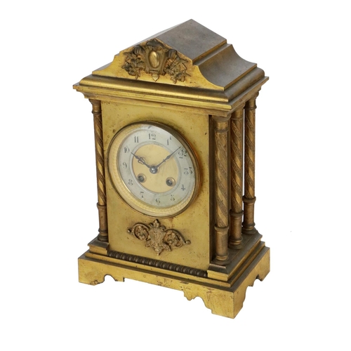 744 - A 19th Century French brass cased and gilt Mantle Clock, the shaped top with embossed cartouche, abo... 