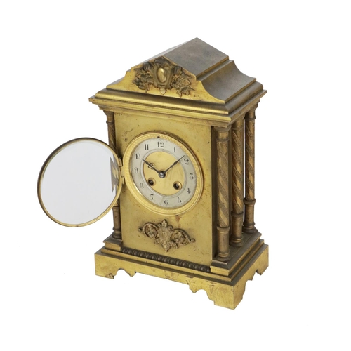 744 - A 19th Century French brass cased and gilt Mantle Clock, the shaped top with embossed cartouche, abo... 