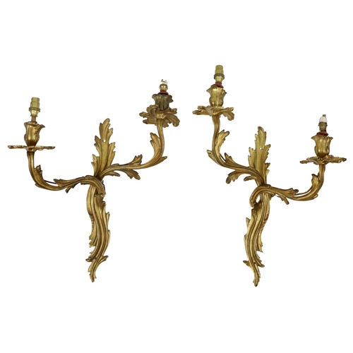 779 - A pair of Louis XV style two branch Wall Lights, with leaf decoration, each approx.  38cms high... 