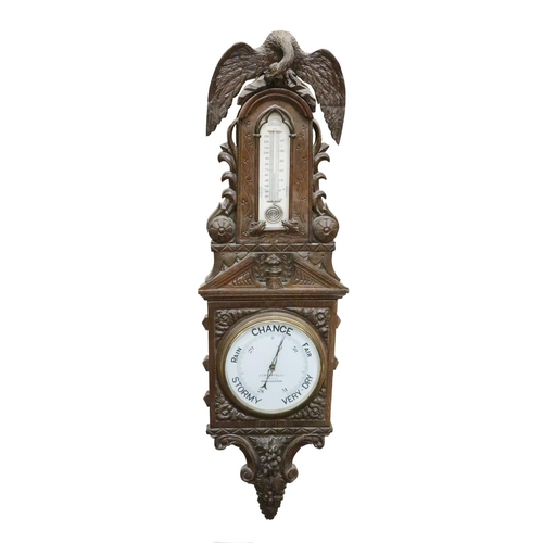 780 - An oversized Victorian oak framed Barometer, with American eagle surmounted over a carved frame with... 