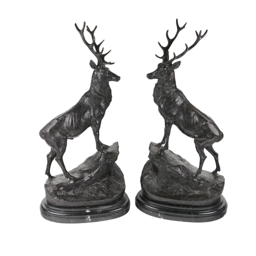 785 - After Jules Moigniez, French (1835-1894)A large pair of bronze Models of Stages, each with twelve po... 