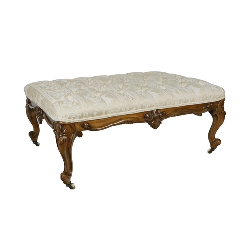 820 - A large Victorian walnut framed Footstool, covered in cream deep button fleur de lys fabric with car... 