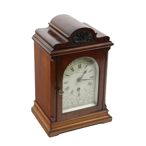 865 - A late Victorian mahogany cased Mantle Clock, with shaped top and relief carving, above an arched pa... 